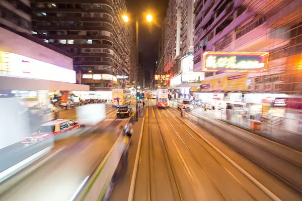 A road with blurred sidewalks and buildings